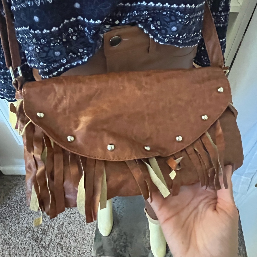 A brown leather purse with tassels!